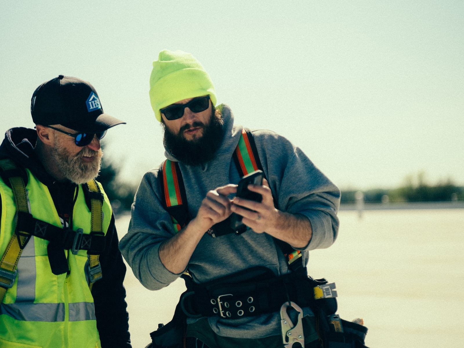 Crew reviews job site photos in construction documentation app.