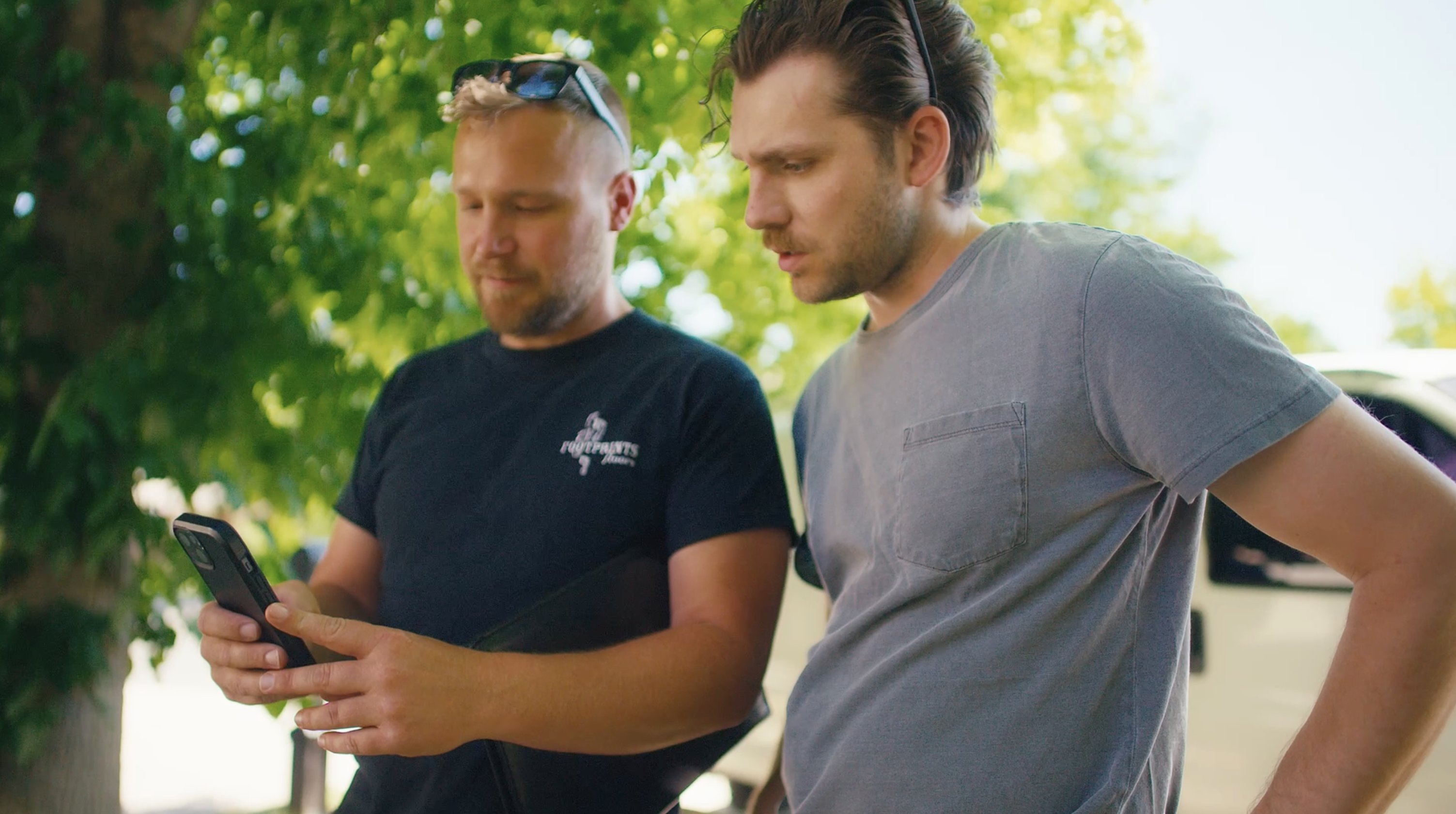 Field team leaders reviewing construction project updates on mobile app