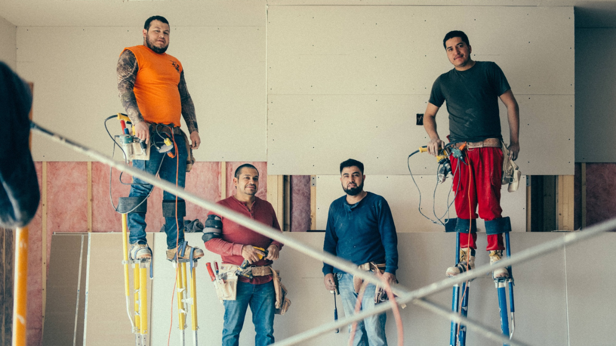 Four contractors in the middle of working on a new construction project