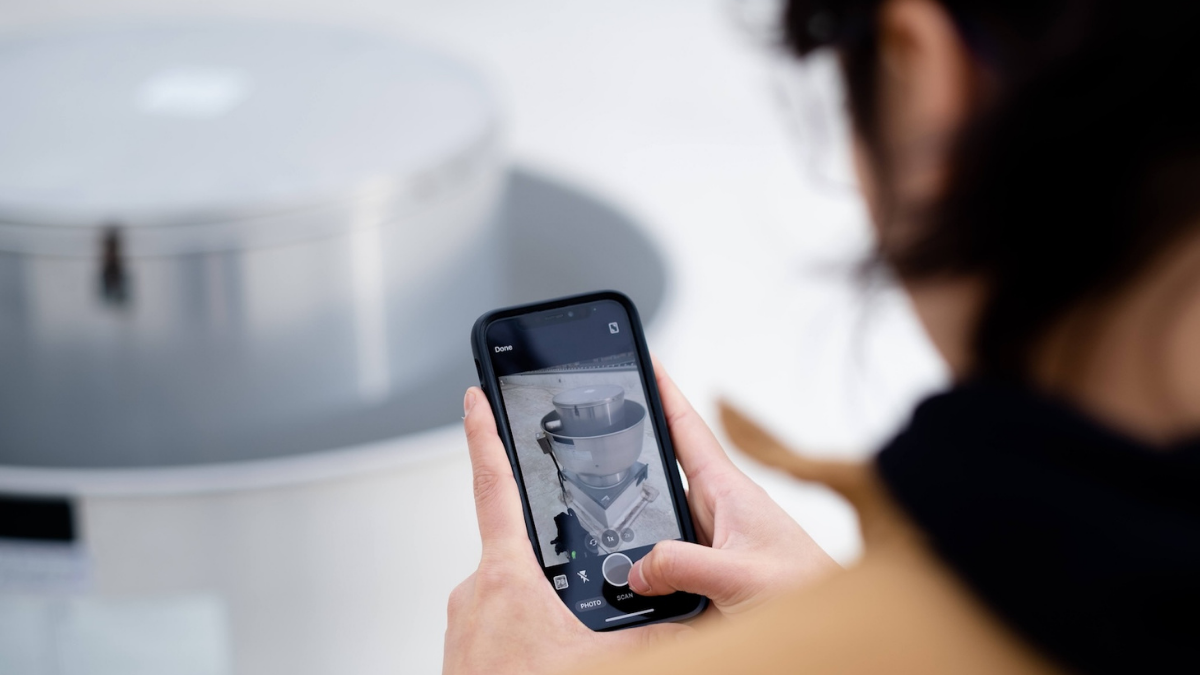 Field tech taking photo of equipment condition with mobile device.