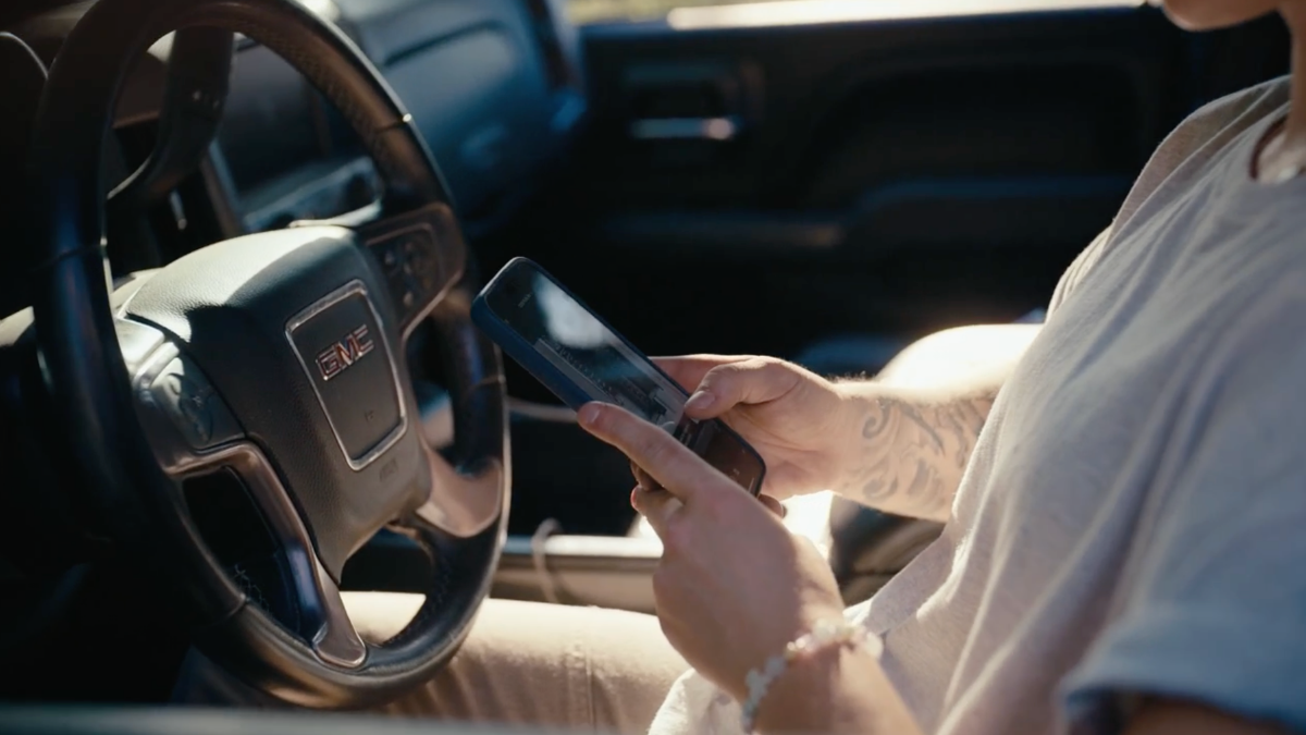 Contractor reviews job details in truck using app.