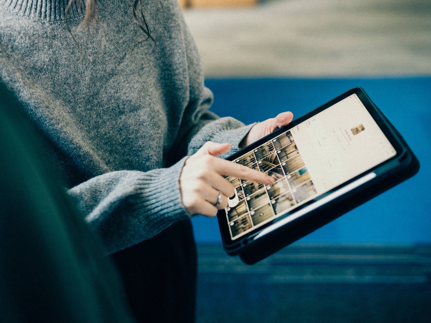 Contractor reviews job site photos on tablet during project walkthrough.