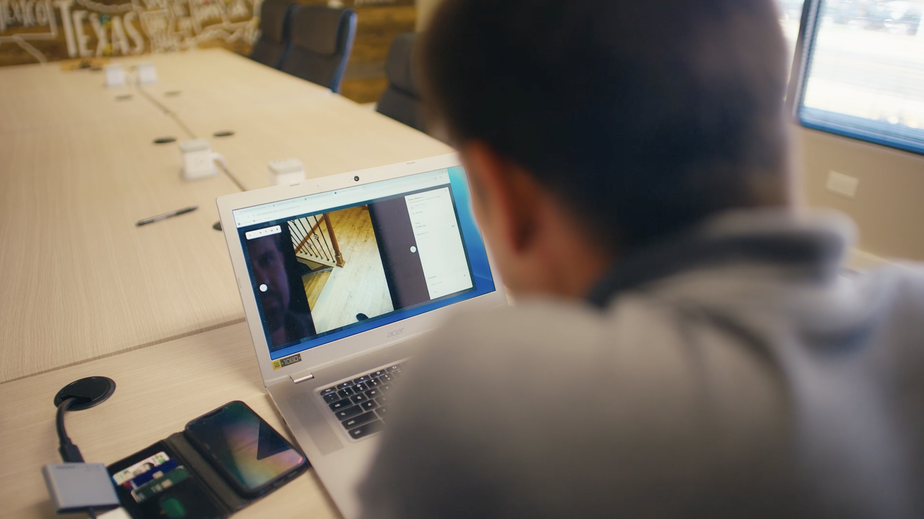 Construction executive reviewing field documentation in office meeting room.