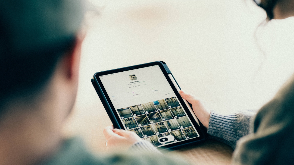 Contractors reviewing project photos documentation in an office setting.