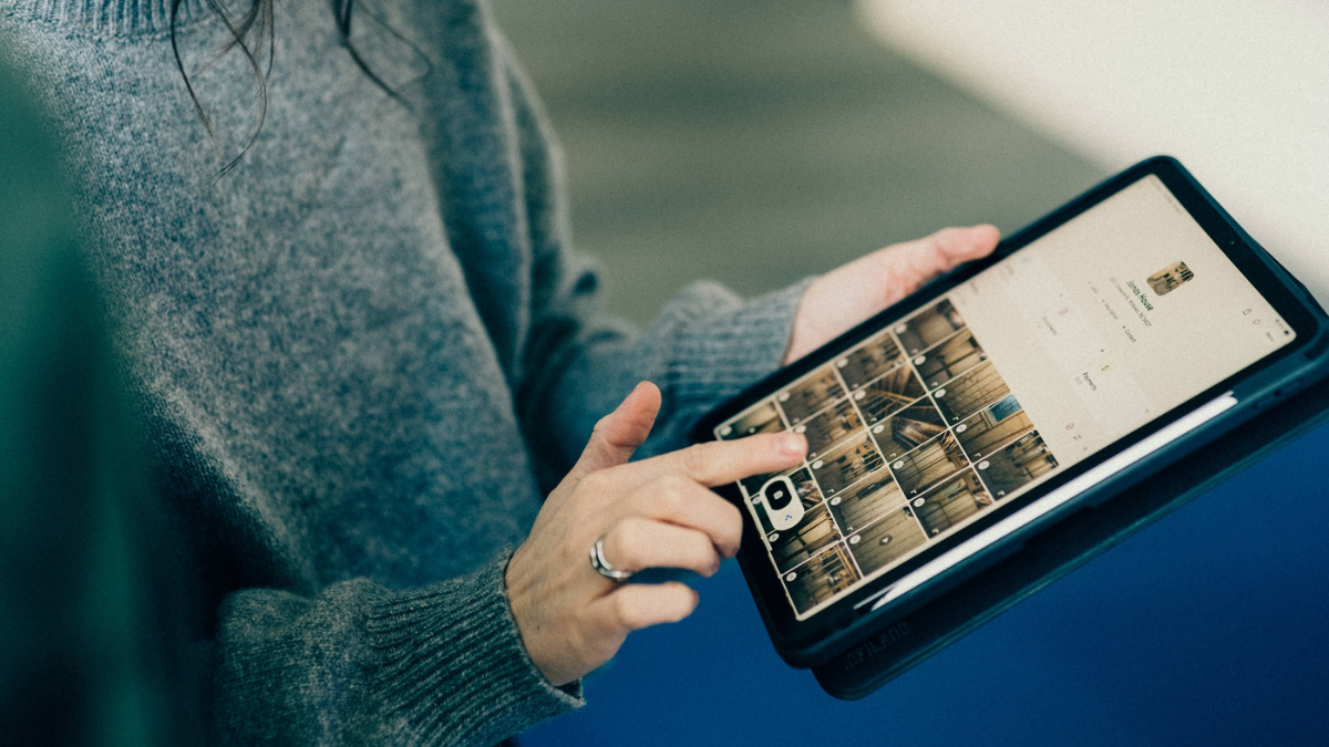 Project manager using a tablet to review job photos and project details.