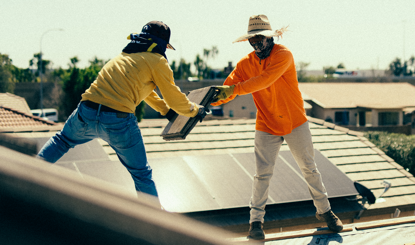 two men working on a roofing project