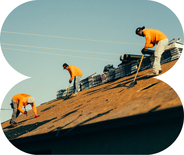 Three men working on a roof.